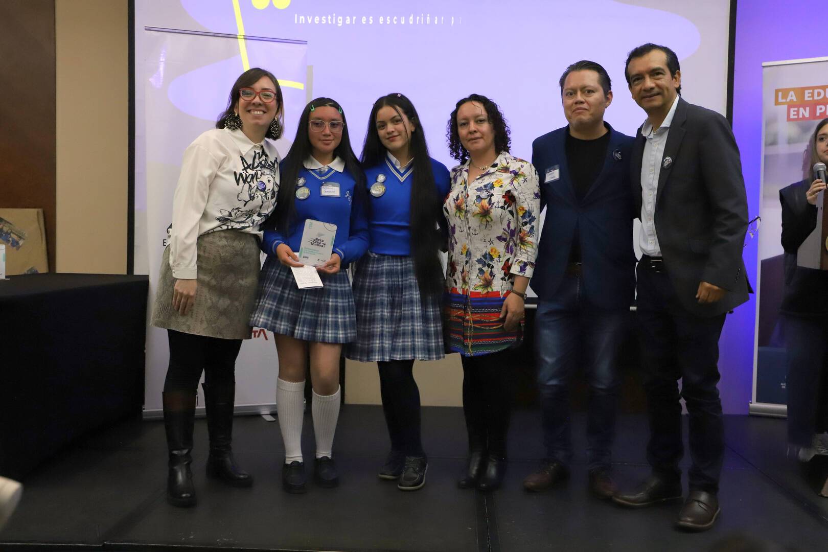 Foto de tres docentes con el Director del Idep y dos estudiantes en uniforme